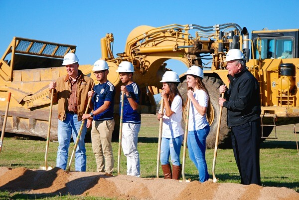 Mayor Alan McGraw, left, and Mayor Pro Tem George White, right, are joined by soccer players from Stony Point High School at the groundbreaking.