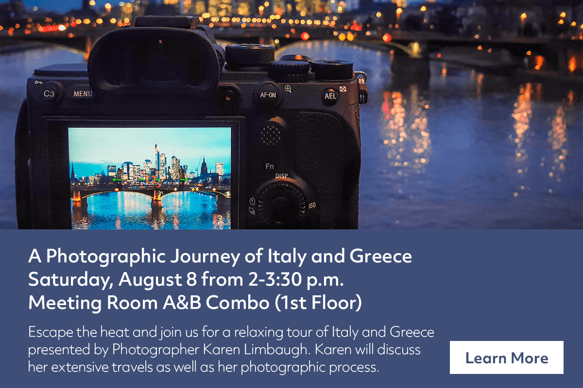 A camera displays a cityscape at dusk over a river. Text below promotes a photography event about Italy and Greece with Karen Limbaugh, on August 8, 2-3:30 p.m., in Meeting Room A&B Combo, first floor.