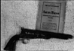 Photo of Sam Bass' gun and a rare book about his life. Courtesy of Red McCooms