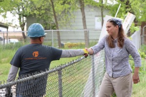 A volunteer greets a Heart of Round Rock resident during a 2014 neighborhood cleanup event.