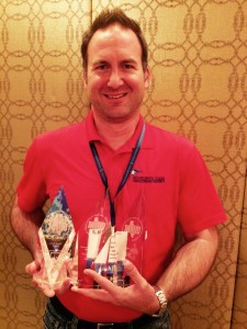 Brian Ligon holding awards