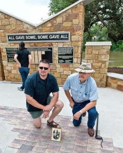Three generations of John Chambers - Sgt. John (Army 2002-2010, on left), Cmdr John S. (Navy WW II, framed photo), and 1/LT John S. (Army 1963-70) - get a photo at the Veterans Monument. The Round Rock Veterans Park Grand Opening and Veterans Monument Dedication was held on Memorial Day, May 25, 2015.  Henry Huey for Round Rock Leader.