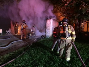 Round Rock firefighters work to extinguish a house fire.