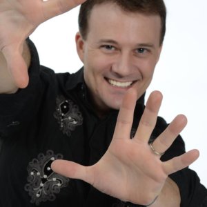 Image shows magician Cody Fisher as seen through his outstretched hands