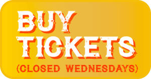 A yellow button with the text BUY TICKETS in bold white letters and (CLOSED WEDNESDAYS) in smaller orange letters below.
