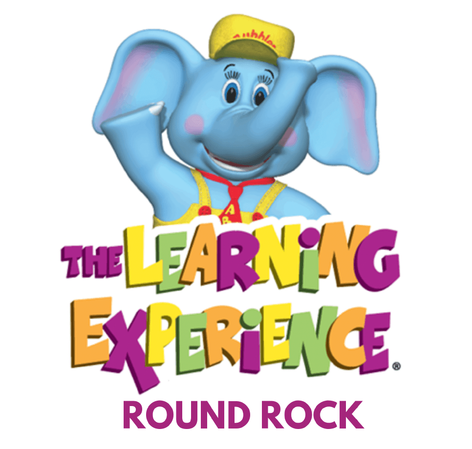 A friendly blue cartoon elephant wearing a yellow cap and suspenders waves above the colorful text The Learning Experience. Round Rock is written below in bold purple letters, celebrating Sertoma Independence Day Parade and Frontier Days.