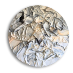 A round abstract artwork with crumpled, textured surface featuring swirling patterns in shades of white, gray, and beige, creating a marble-like effect. The piece casts a soft shadow on a white background.