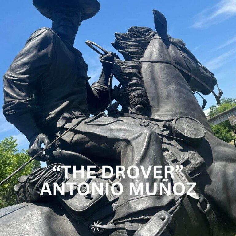 A close-up of a bronze statue of a cowboy riding a horse, with trees and blue sky in the background. White text over the image reads: “THE DROVER” ANTONIO MUÑOZ.