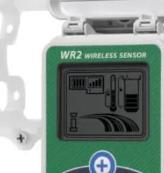 Close-up of a WR2 wireless sensor display showing signal bars, a thermometer, a battery icon, and curved lines representing sensor data or water flow.