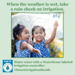 Two young girls in blue dresses smile and play under a transparent umbrella in the rain. Text encourages checking irrigation in wet weather and promotes WaterSense labeled controllers for smart irrigation. #SmartIrrigationMonth.