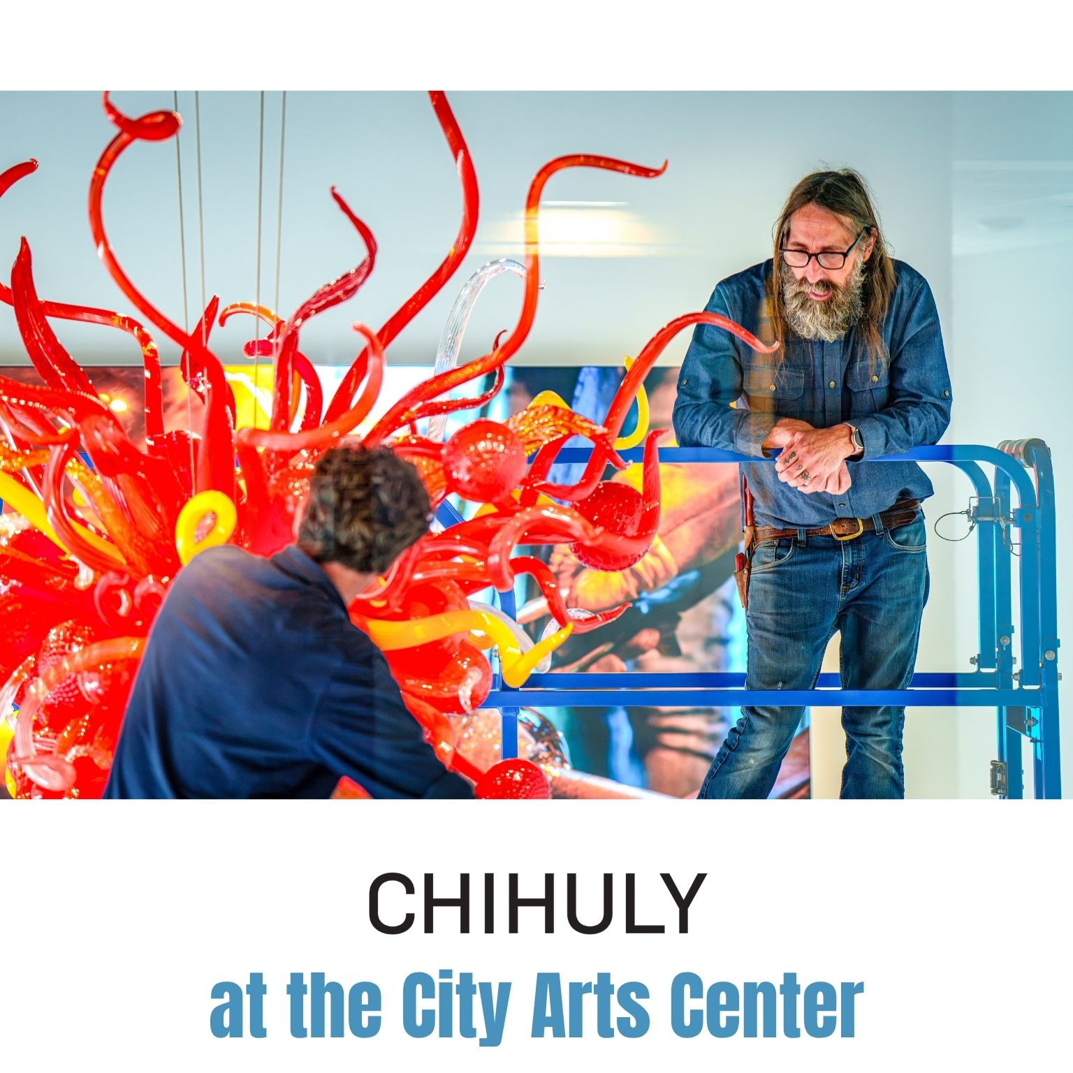 Two people work on a colorful, intricate glass sculpture with swirling red and yellow shapes. One stands on scaffolding, the other is below. Text reads CHIHULY at the City Arts Center..