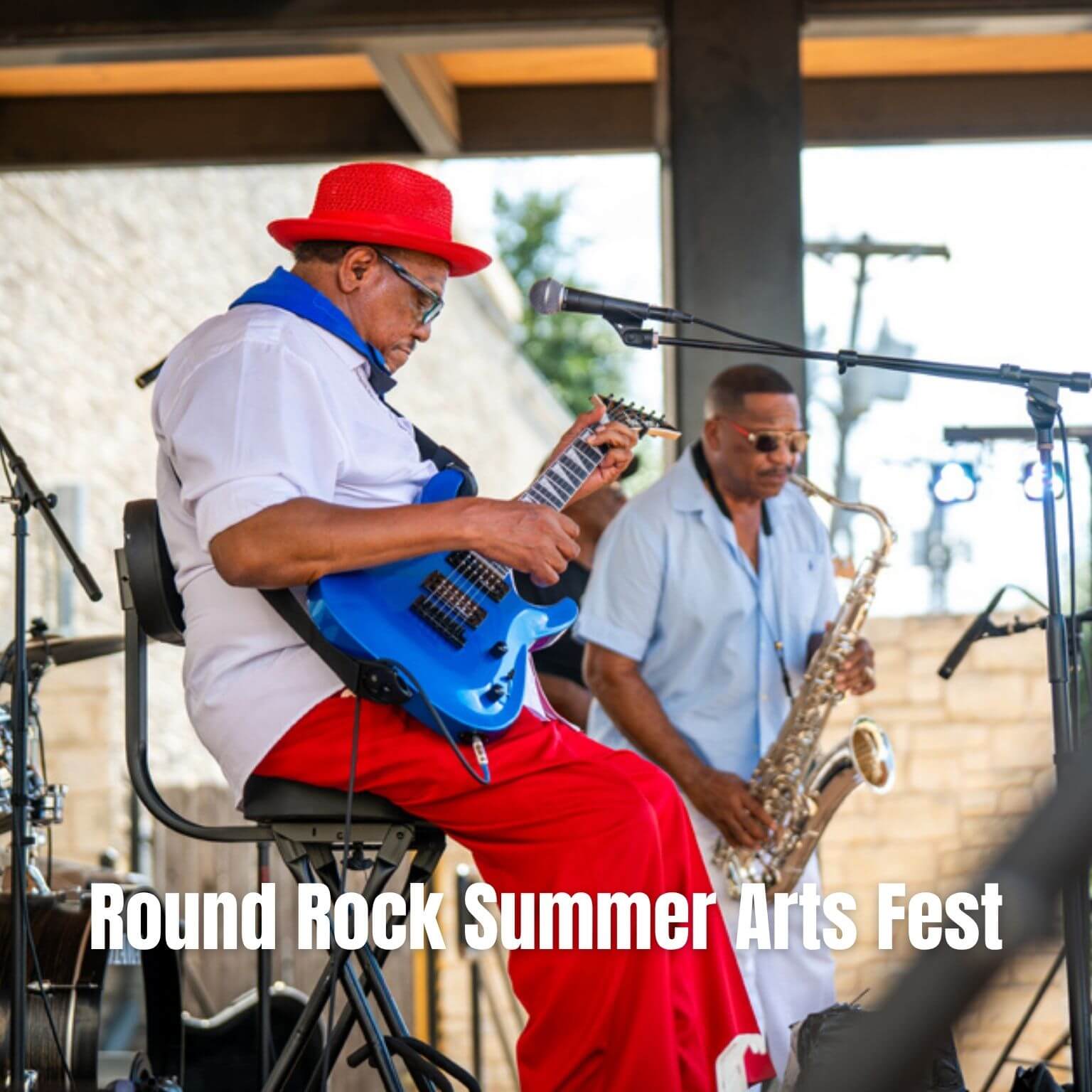Two musicians perform on stage; one plays a blue electric guitar, the other a saxophone. Both wear sunglasses. Text reads, Round Rock Summer Arts Fest. Outdoor setting with bright daylight.
