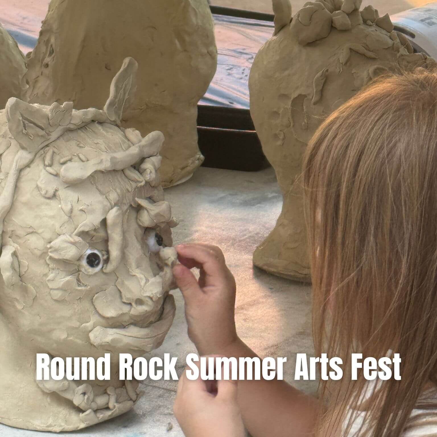 A child adds details to a clay sculpture of a face at an arts festival. Other unfinished clay heads are visible in the background. Text reads: Round Rock Summer Arts Fest..